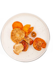 dried fly agaric mushroom on a plate on a white background