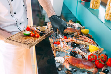 The Chef puts the seafood on a tray in the restaurant.