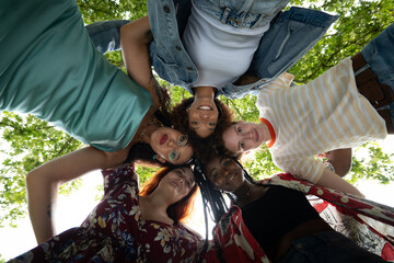Cinematic shot of young girl friends of different ethnicities are having fun together in green city park on sunny day. Concept of friendship, lifestyle, youth,diversity,multiethnic,
happiness, freedom