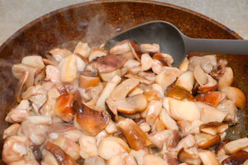 The boletus is fried in a pan. Cooking porcini mushrooms in a frying pan close-up view. delicious and fresh porcini mushrooms are cooking