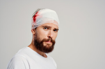 patient bandaged head and hand blood treatment