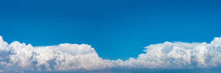 Panorama clear blue sky with cumulus clouds over sea. Colorful seascape with horizon line.