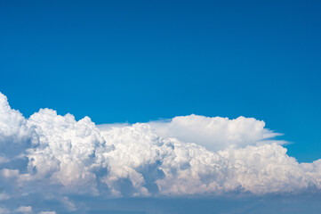 White lush cumulus clouds over sea. Lush clouds