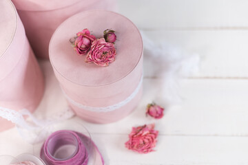 Beautiful pink round gift wrapping is decorated with narrowed roses. 