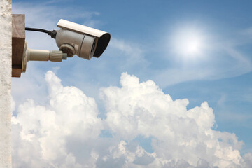 CCTV camera system on blue sky background.