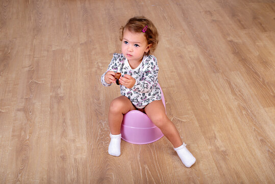 Little girl 2 years  learns to sit on a chamber-pot. Diaper weaning