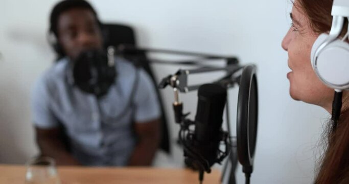 Hosts having podcast session together - Female speaker making an interview during live stream
