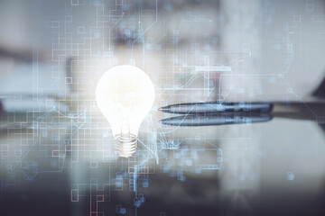 Double exposure of light bulb hologram over coffee cup background in office. Concept of idea