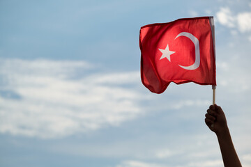 Close up shot of a waving Turkish flag on hand.