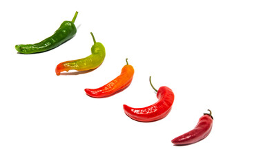 Red, green and orange chili peppers on a white background. Isolated