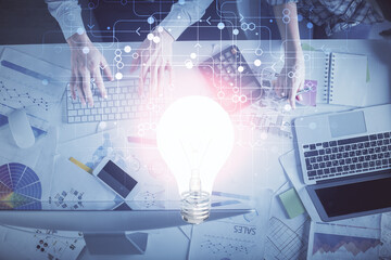 Double exposure of man and woman working together and bulb drawing. Computer background. Top View. Idea concept.