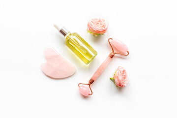 Face massage set with essential oil. Gua sha stone and roller