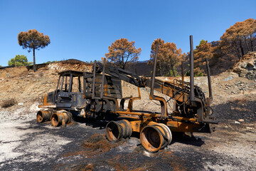 Heavy machinery burned by fire in the Jubrique fire next to Sierra Bermaja in the Genal Valley, Malaga. Spain. September 2021