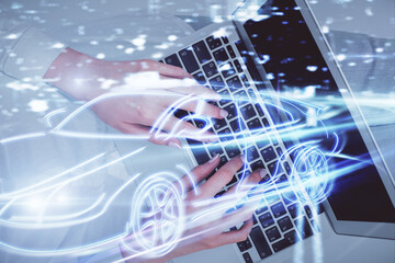 Double exposure of woman hands working on computer and car hologram drawing. Top View. Auto pilot concept.