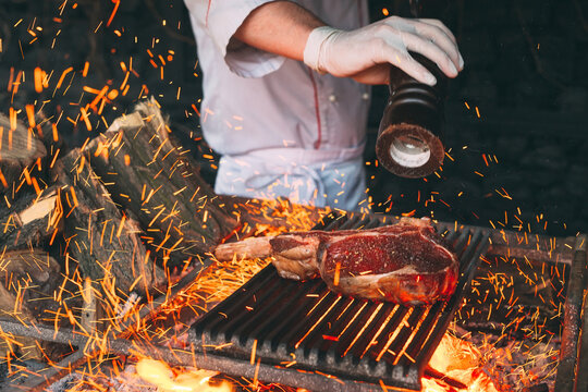 Chef pepper the steak on fire.