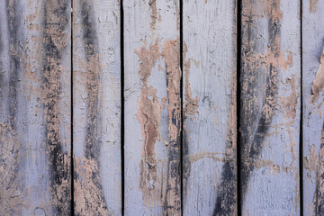 Boards with traces of old peeled paint. Old wooden wall.