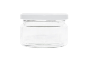 Round empty transparent glass jar with a white lid. Glass jar for spices. Isolated on white background.