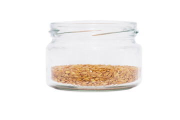 Flax seeds in a transparent glass jar. Isolated on white background. Condiments and spices.