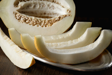 Melon, honey melon on wooden table background.
