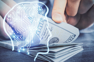 Multi exposure of brain drawing hologram and us dollars bills and man hands. Ai invest concept