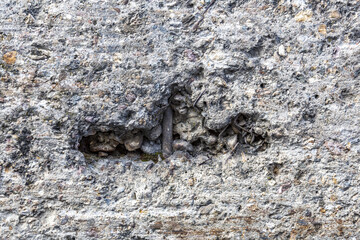 Textured surface of gray concrete wall with scratches and cracks