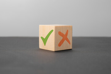 pros and cons concept. wooden cube with a green check mark and a red cross. Concept of positive or...