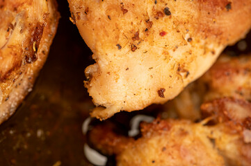 Fried pieces of meat in a frying pan, close-up, selective focus.