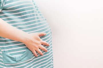 臨月を迎えた妊婦のお腹の写真。妊娠後期の妊婦のイメージ。