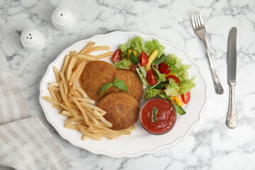 Delicious fried breaded cutlets with garnish served on white marble table, flat lay