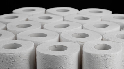 Toilet Paper. Rolls Of White Soft Multi-Layer Toilet Paper isolated on black background. Concept Of Care, cleanliness, Hygiene