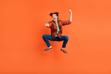 Full size photo of cheerful funky carefree male jumping rodeo cowboy ranch isolated on bright orange color background - obrazy, fototapety, plakaty
