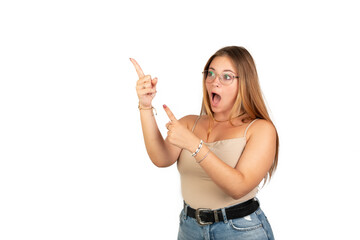 Fototapeta na wymiar Surprised blonde woman pointing left upper corner with both hands. White background. 20 - 22 years old. White European woman.