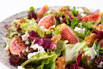 Figs salad with cheese and walnuts isolated on white background. Close up
