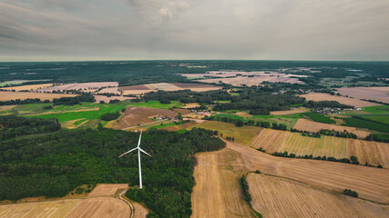Aerial photo of windmills and blue sea at sunset