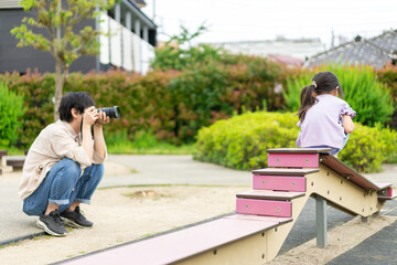 Fototapeta premium 子供の成長を写真で撮るお父さん