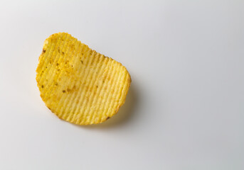 Single potato crinkle chip isolated on white background with text space
