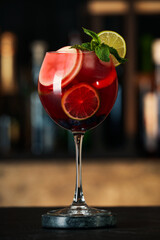Delicious sangria cocktail on black table in bar