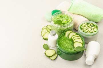 Obraz na płótnie Canvas Homemade cosmetics with cucumber. Natural cream, sea salt, body lotion, and soap
