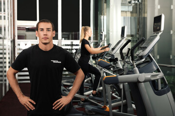 Fototapeta na wymiar Portrait of personal trainer in modern gym