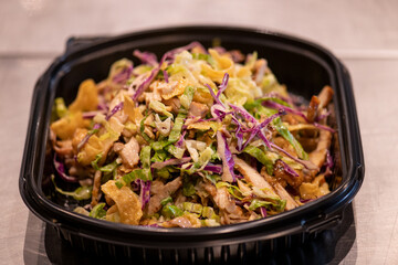 Penne pasta in tomato sauce and cheese decorated with basil on a wooden background, top view