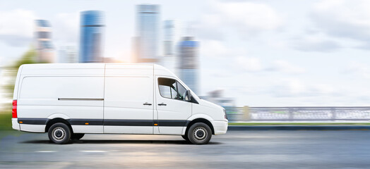 White van drive on a city road at sunset cityscape background. © Soho A studio