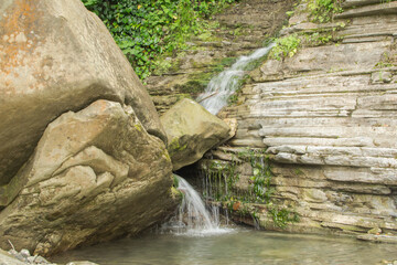 Fototapeta na wymiar waterfall among rocks and rocks in the Mammadov gorge