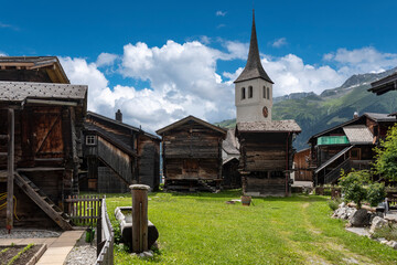 Fototapeta na wymiar Historic village centre in Bellwald with tower of the parish church
