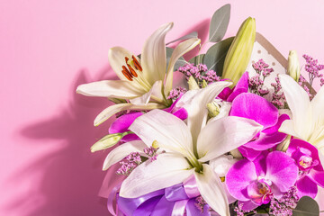 A beautiful bouquet of fresh flowers on a pink background