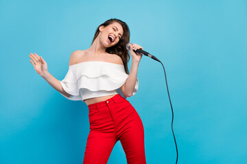 Portrait of attractive cheerful careless dreamy girl singing hit having fun rest isolated over vibrant blue color background - obrazy, fototapety, plakaty