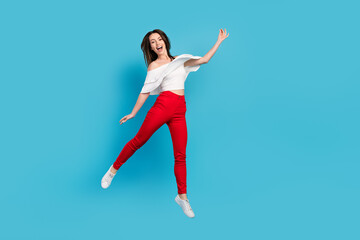 Fototapeta na wymiar Full body photo of cool brunette millennial lady jump wear blouse jeans isolated on blue color background