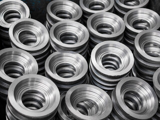 Piles of the gear blanks with bore, close up. Manufacturing of cylindrical gears