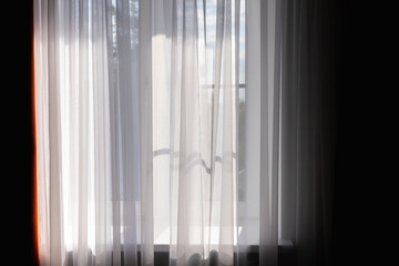 Wavy white tulle in front of bright window