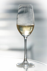 A crystal champagne flute with Champagne wine against a bright background
