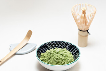 powdered matcha tea with the utensils to prepare it